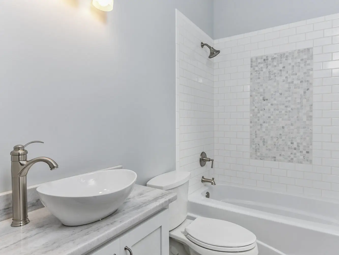 modern bathroom, vessel sink, granite countertops, white vanity, tile tub surround