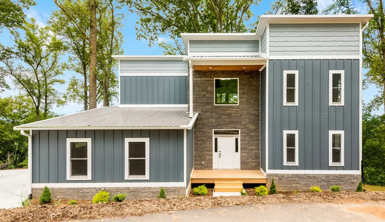 Home Builder Asheville NC, Custom Home, Modern Blue exterior siding House, 2 car white garage door, flat roofline