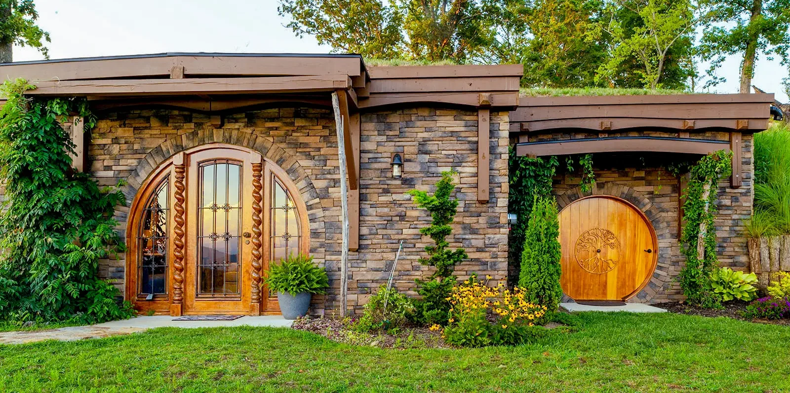 New Construction home stone siding, flat roofline, cedar wood doors