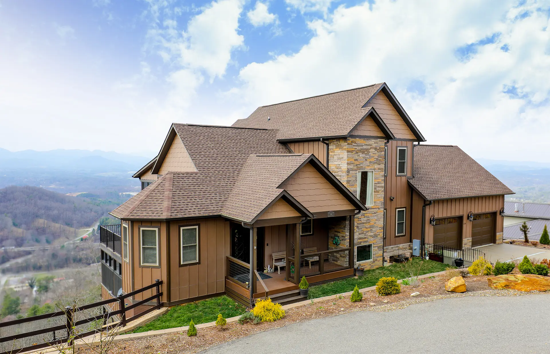 New Construction Custom Home, brown exterior siding with brown roof shingles, composite decking front porch with blue ridge mountains