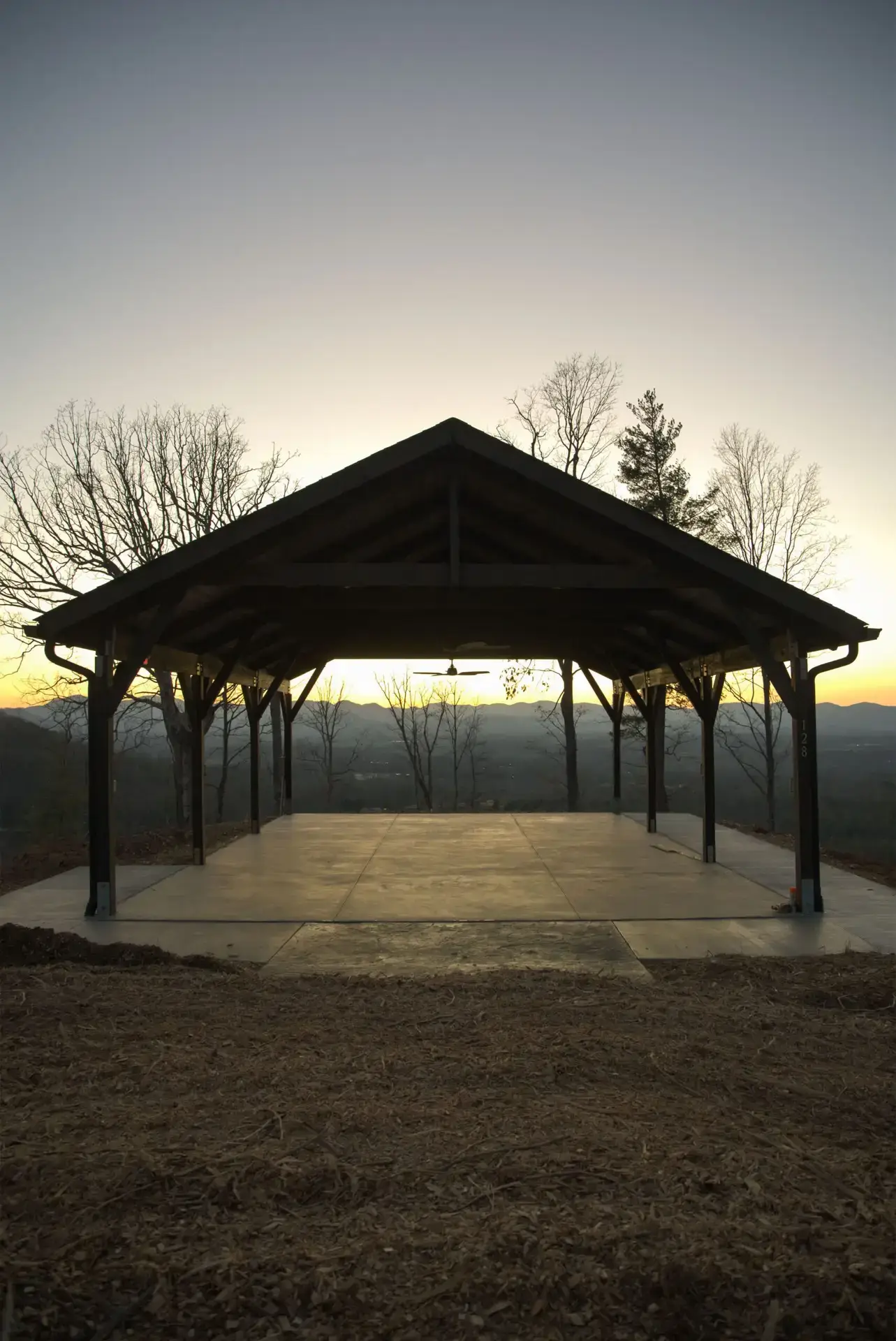 new construction build village castle style with stone exterior gray siding gray roofing