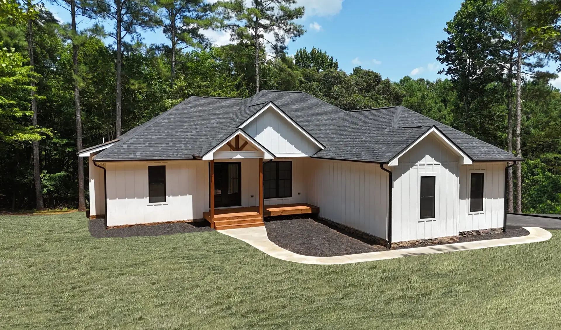 new construction white modern farmhouse front with green grass frontward, gray roof shingles 