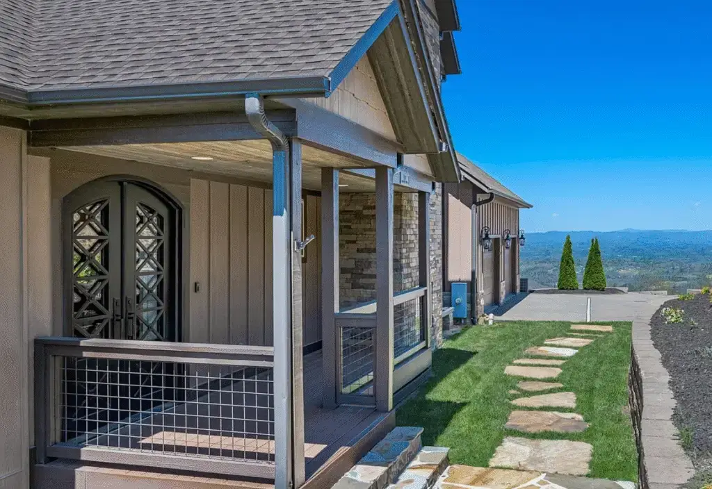 New Construction Custom Home, brown exterior siding with brown roof shingles, composite decking front porch with blue ridge mountains