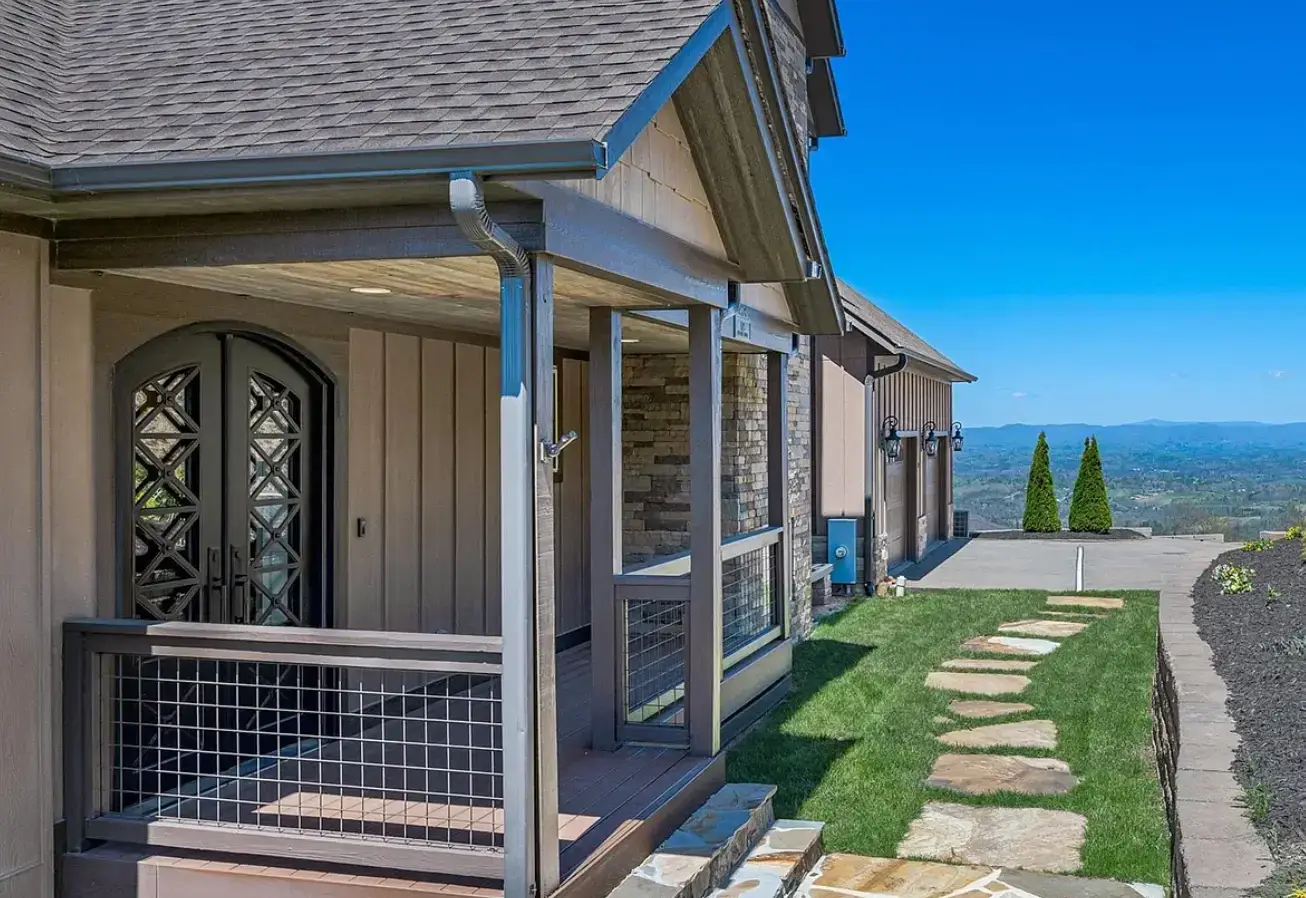New Construction Custom Home, brown exterior siding with brown roof shingles, composite decking front porch with blue ridge mountains
