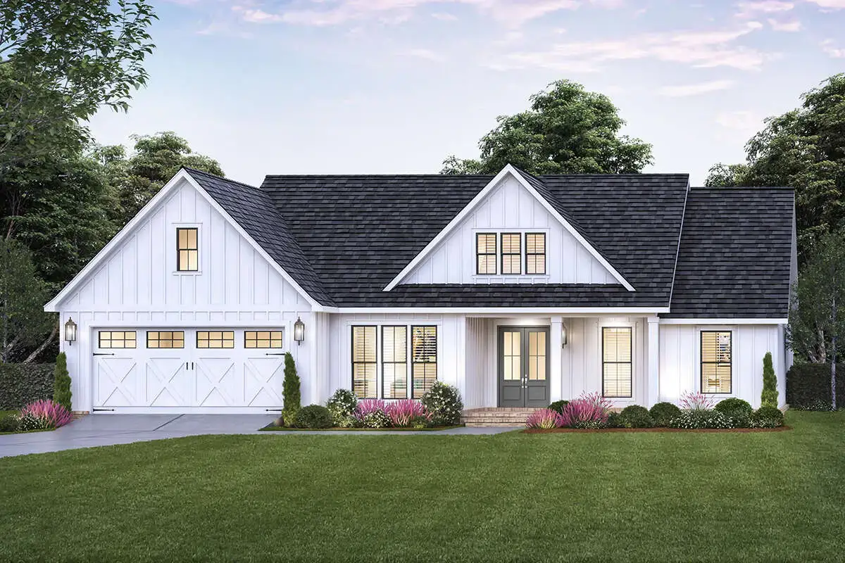 Modern white farmhouse with black trim and attached two-car garage