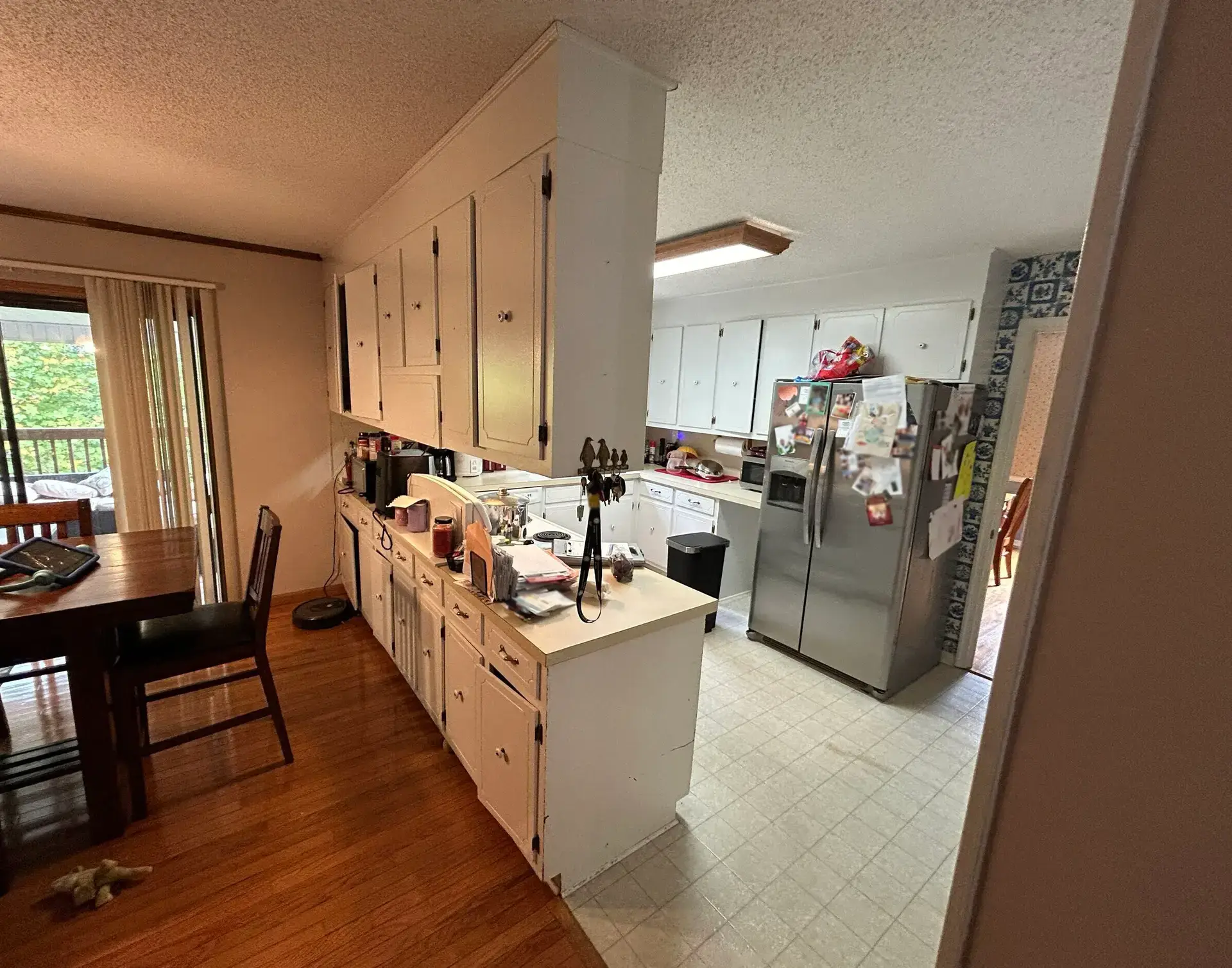 kitchen with white cabinets, tile countertops